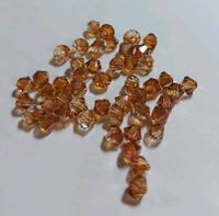 9 Tüten Swarovski ® Kristalle 4mm Doppelkegel Bernstein Färbung Niedersachsen - Bockenem Vorschau