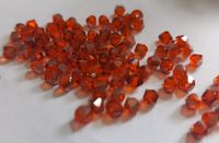 9 Tüten Swarovski ® Kristalle 4mm Doppelkegel orange Schimmer Niedersachsen - Bockenem Vorschau