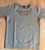 Grauer Tchibo Pullover mit Strasssteinen Größe 36/38 Hessen - Biedenkopf Vorschau