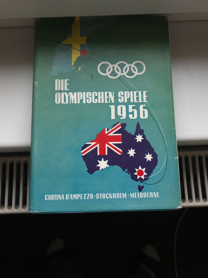 Buch „ Die Olympischen Spiele von 1956“, antik in Schiffweiler