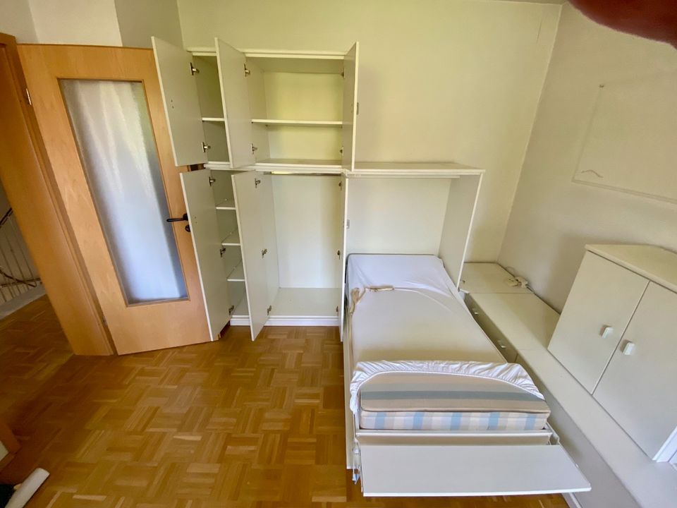 weißes Schrankwandsystem mit klappbaren Einzelbett in Düsseldorf