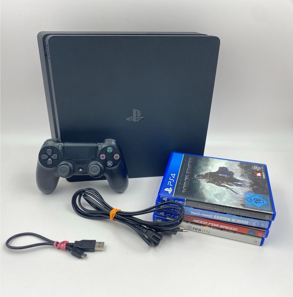 PlayStation 4 mit Spielen und Controller in Osteel