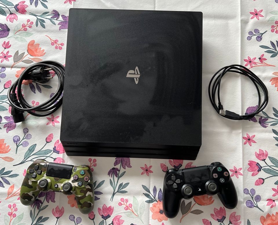 PlayStation 4 Pro mit Controller und Spielen in Kamen