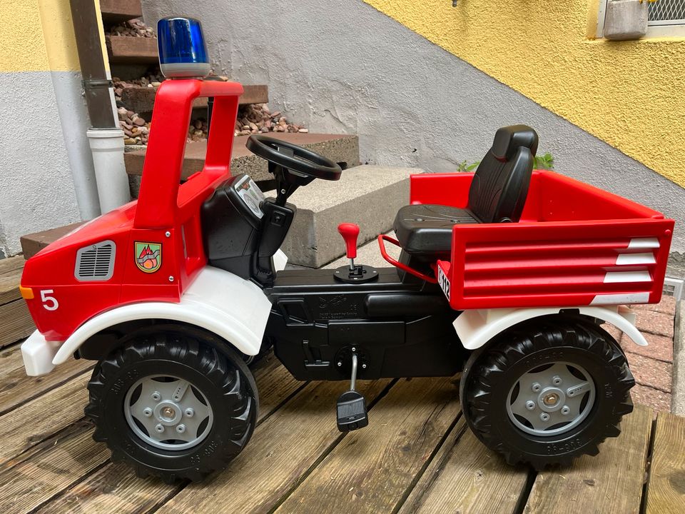 Rolly Toys Unimog Feuerwehr Tretfahrzeug Garten Outdoor Spielzeug in Rimpar