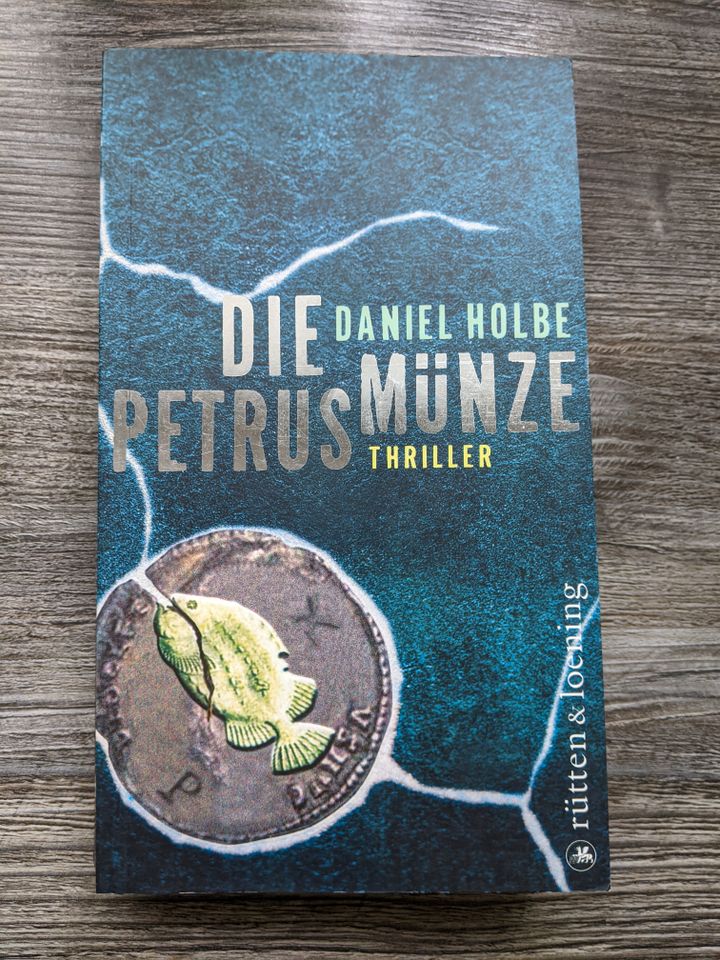Daniel Holbe DIE PETRUSMÜNZE TB Thriller neuwertig ISBN 978335200 in Ettlingen